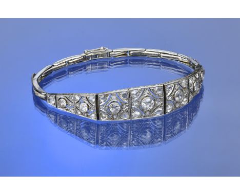 Art Deco 18ct white gold and platinum bracelet set with transitional cut diamonds in nine pierced panels, the largest diamond