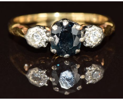 An 18ct gold ring set with a sapphire and two diamonds, 3.4g, size N
