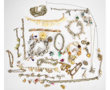 A collection of jewellery including nine silver charms, white metal charm bracelet, single ruby earring, section of pendant s