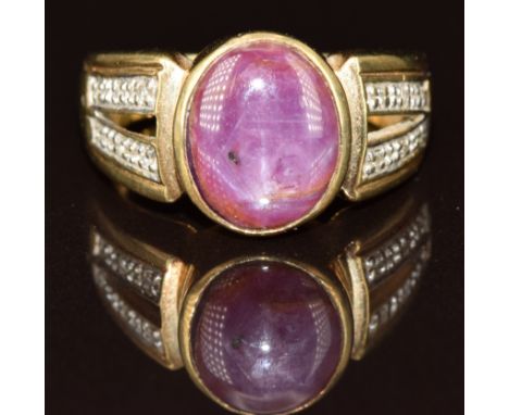 A 9k gold ring set with a star ruby cabochon and diamonds, 6.2g, size N