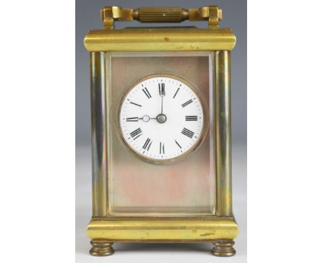 Late 19th or early 20th century carriage clock with bevelled glass panels, circular enamel dial and visible escapement, heigh