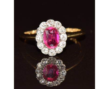 An 18ct gold ring set with an oval cut synthetic pink&nbsp;sapphire of approximately 0.7ct&nbsp;surrounded by diamonds, 2.8g,