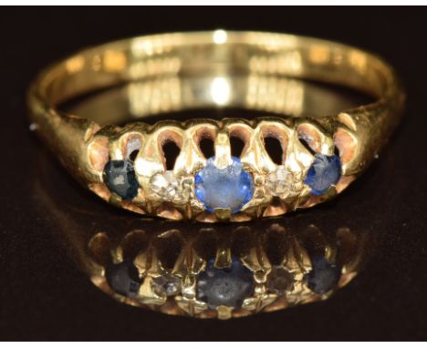 A c1920 18ct gold ring set with three sapphires and two diamonds, 2.7g, size S