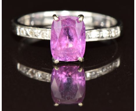 An 18ct white gold ring set with a pink sapphire of approximately 2ct and diamonds to the shoulders, 2.8g, size M