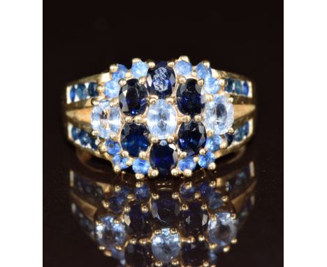 A 9ct gold ring set with sapphires and topaz in a cluster, 5.2g, size O