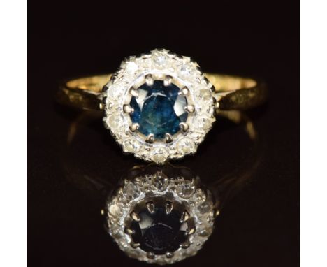 An 18ct gold ring set with a sapphire surrounded by diamonds, 3.1g, size M