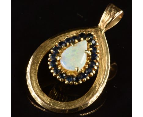 A 9ct and 18ct gold pendant set with a pear cut opal surrounded by sapphires, 7.3g, 3.5 x 2.2cm
