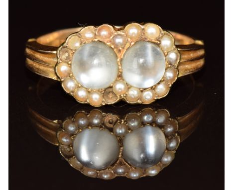 A 15ct gold ring set with two moonstone cabochons surrounded by seed pearls (two missing), Chester 1900, size T, 4.5g