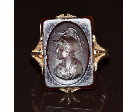 A c1920 9ct rose gold ring set with an agate intaglio depicting a warrior, 5.2g, size H