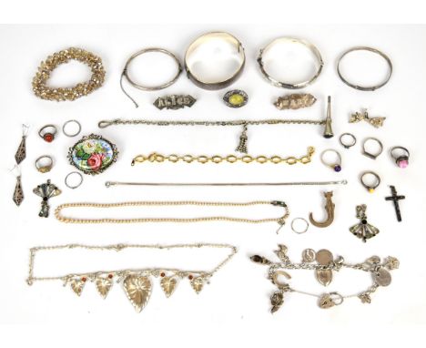 A collection of silver jewellery including for bangles one by Charles Horner, charm bracelet with nine charms, seven rings, b