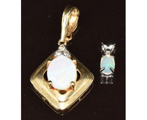 A 14k gold pendant set with an opal cabochon and diamonds and a 14k white gold pendant set with an opal cabochon, 3.4g