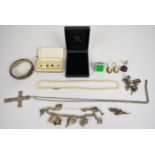 A collection of silver jewellery including charm bracelet with eight silver charms, Swedish brooch