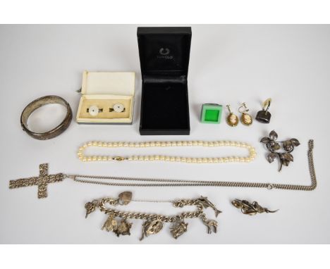 A collection of silver jewellery including&nbsp;charm bracelet with eight silver charms, Swedish brooch by MIC Neugel, brooch