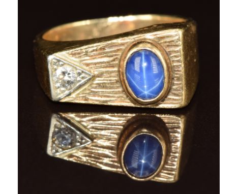 A 9ct gold ring set with a star sapphire and diamond, 10g, size T