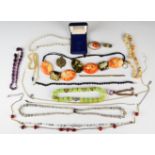 A collection of costume jewellery including agate necklaces, Art Deco beads, silver ring, rolled