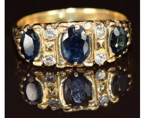 An 18ct gold ring set with three sapphires and four diamonds, 5g, size O