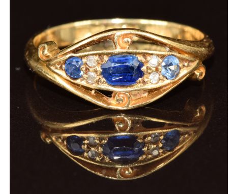 An 18ct gold ring set with three spinel and four diamonds, Birmingham 1918, 3.1g, size N