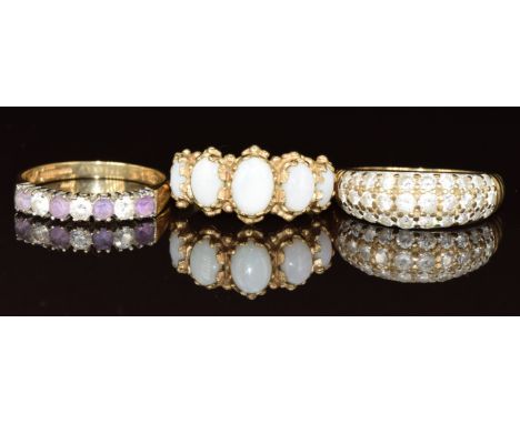 Three 9ct gold rings, one set with five opal cabochons, one cubic zirconia and the other amethysts and cubic zirconia, 7.4g, 