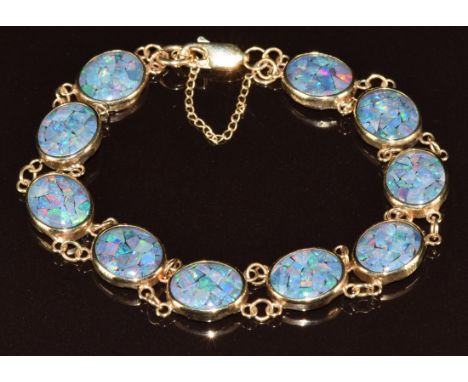 A 9ct gold bracelet set with opal mosaic panels, 11.2g, 18cm
