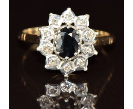 A 9ct gold ring set with an oval cut sapphire surrounded by diamonds, 3.2g, size Q