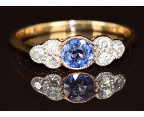 An 18ct gold ring set with a round cut sapphire of approximately 0.35ct and six diamonds, 1.9g, size L