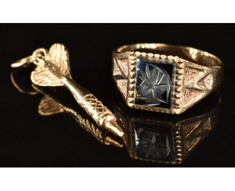 A 9ct gold ring set with a hematite intaglio and a 9ct gold charm in the form of a dart, 4g, size I