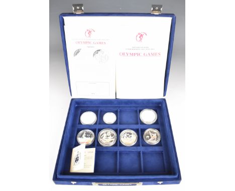 Six 925/1000 silver 31.47g Olympic coins together with a 500/1000 10g silver examples, all but one with certificate