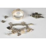 A hallmarked silver bangle by Charles Horner (Chester 1945), silver charm bracelet with eight silver
