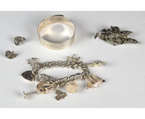 A hallmarked silver bangle by Charles Horner (Chester 1945), silver charm bracelet with eight silver charms and a silver broo