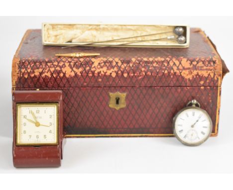 A silver pocket watch, three hatpins including two with white metal tops, travelling clock and brooch