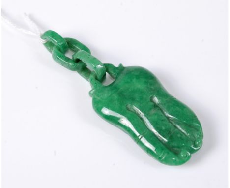 A modern jade carving, with octopus like tendrils and a carved three link chain, 9.5cm long