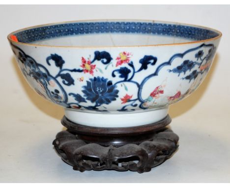 An 18th century Chinese export porcelain bowl, each panel depicting figures amidst landscape, with further blue floral border