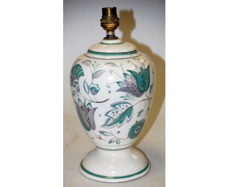 A mid-20th century Poole pottery table lamp base, on a white ground with green floral decoration, impressed Poole England mar