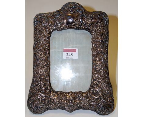 A circa 1900 silver and embossed easel photograph frame, 23cm