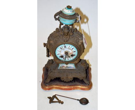 A late 19th century French gilt metal mantel clock, having porcelain inset dial with Roman numerals and eight day movement, t