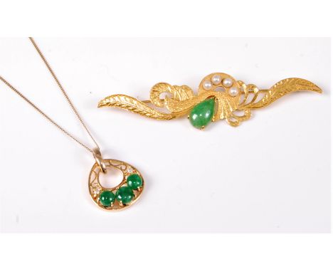 A jade and diamond pendant, the three round jade cabochons and two small diamonds set in an open pear shaped fretwork of yell