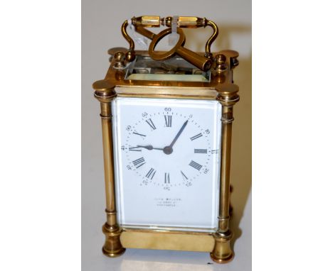 An early 20th century lacquered brass cased carriage clock, the enamel dial with Roman numerals and outer Arabic numerals, si