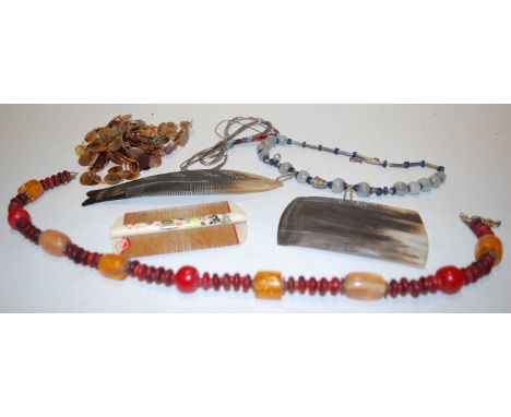 A small collection of miscellaneous items, to include; glass necklace, carved horn comb etc 