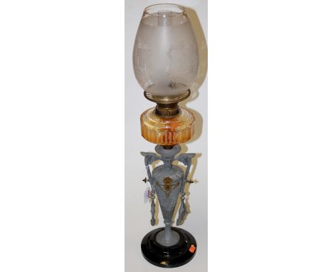 An early 20th century oil lamp, having etched clear glass shade above a clear glass reservoir, on twin handled urn shaped bas