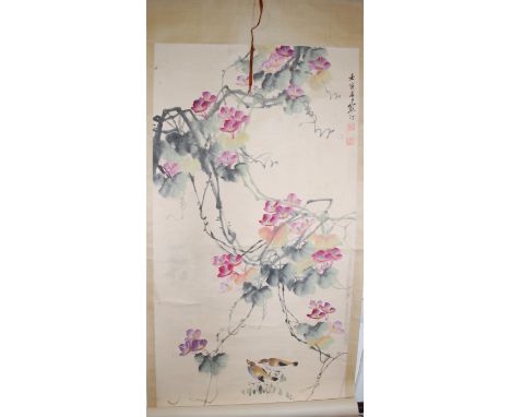 A large Chinese scroll painting depicting birds amongst foliage, signed and with seal marks 