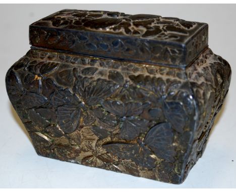 An early 20th century Chinese white metal tea caddy of bombe form relief decorated with butterflies, width 12cm