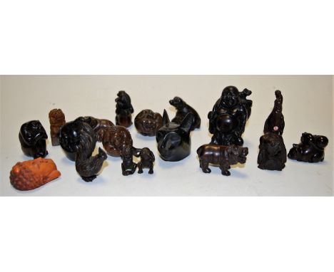 A Japanese hardwood netsuke, carved in the form of a seated monkey; together with various other carved hardwood netsuke and b
