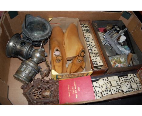 A box of miscellaneous items, to include; a Miller cycle lamp, pair of cobbler's lasts, dominoes etc 