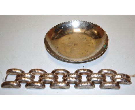 An unmarked white metal bangle having foliate engraved decoration together with continental white metal shallow bowl 