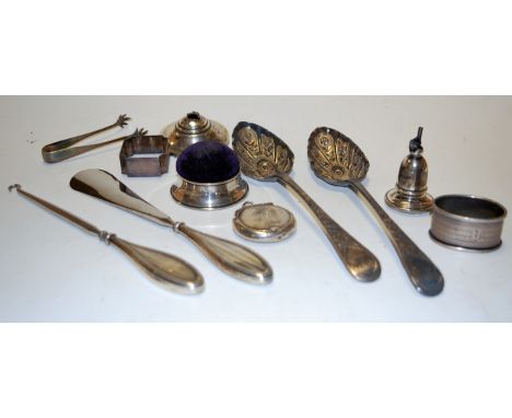 A pair of 19th century and later embossed silver berry spoons; together with a silver mounted pin cushion, silver napkin ring