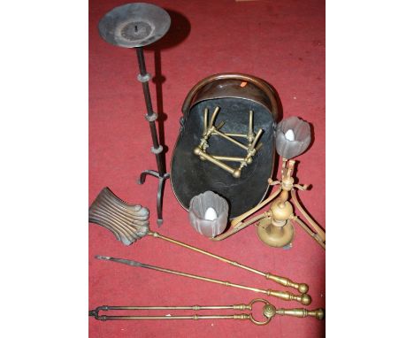 An early 20th century copper helmet shaped coal scuttle; together with a pair of turned brass fire-dogs, a three-branch elect