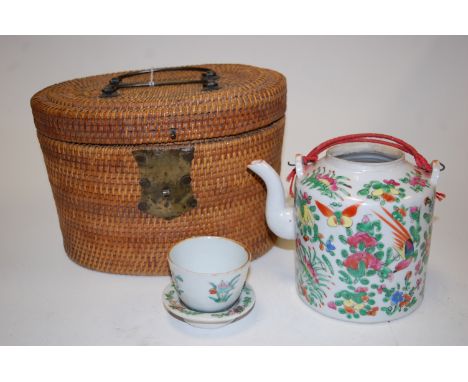 A Chinese Republic porcelain teapot, having typical enamelled floral decoration, with matching tea bowl, in fitted wicker cas