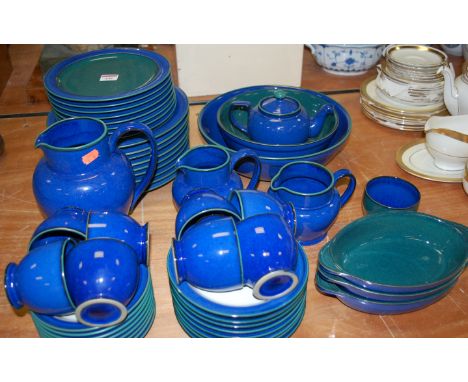 A Denby stoneware eight place setting tea and dinner service, on a deep blue / green ground