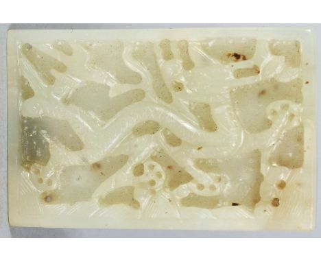 A FINE QUALITY CHINESE YUAN/MING DYNASTY WHITE JADE RECTANGULAR PLAQUE, deeply carved with a dragon above stylised waves, 2.3