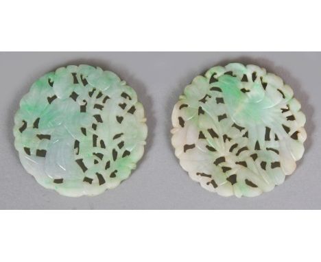 A PAIR OF EARLY/MID 20TH CENTURY CHINESE APPLE GREEN CIRCULAR JADE PLAQUES, one carved and pierced with a phoenix and foliage